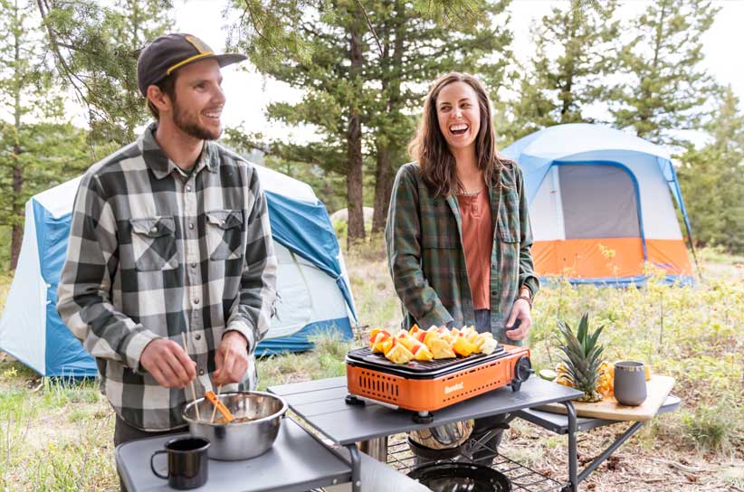 Campers cooking on the SPRK Camp Grill