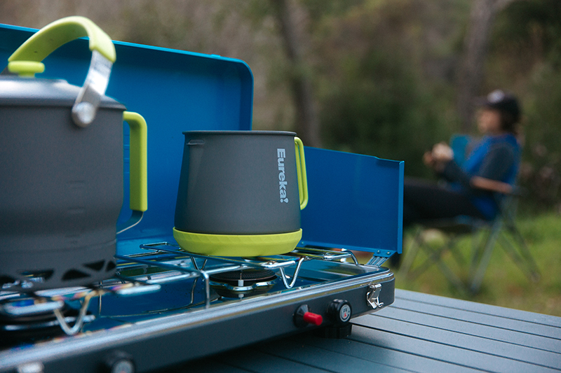 A coffee pot warms up on a camp stove. 