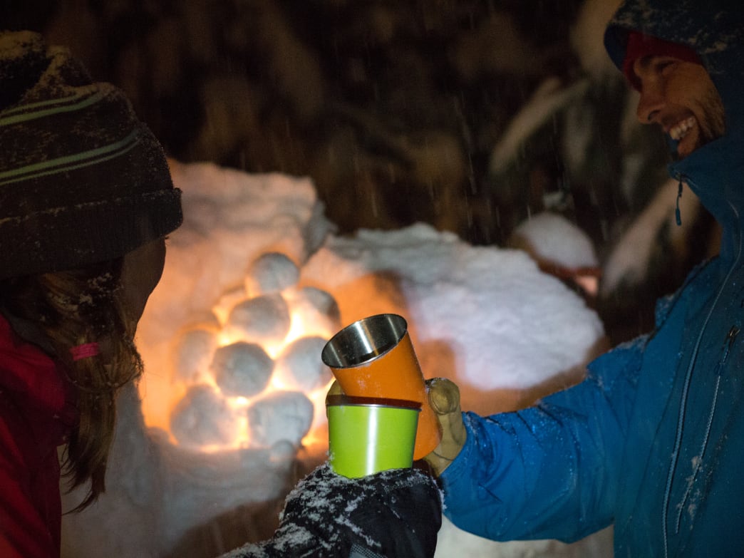 A couple enjoying beverages in the snow