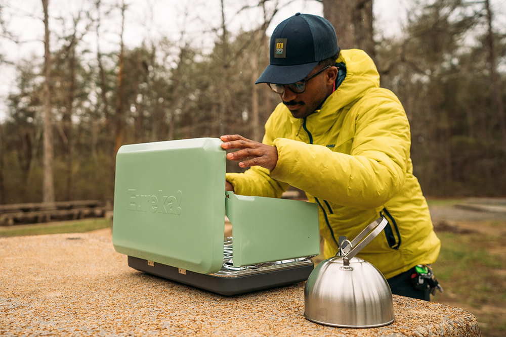 Caziah Franklin sets up his Eureka Ignite camp stove on a picnic table. 