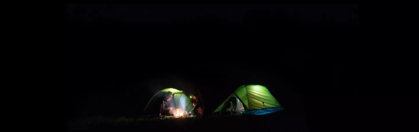 Eureka backpacking tents at night.