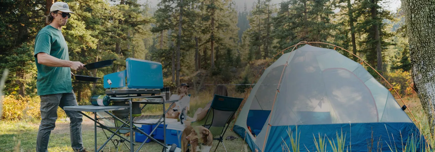 Summer campsite with tent and camp stove