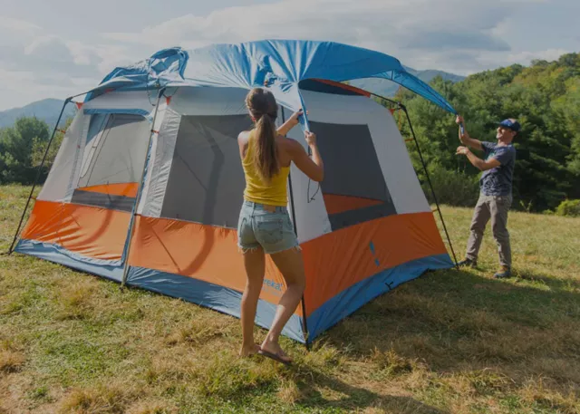 Two people setting up the Eureka Copper Canyon LX 4 Tent
